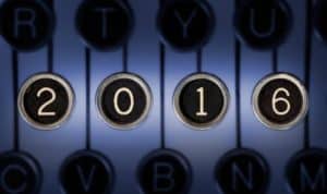 Image of old typewriter keyboard with scratched chrome keys that form "2016". Lighting and focus are centered on "2016".