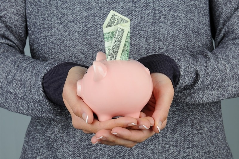 financial wellness programs - putting money in the piggy bank